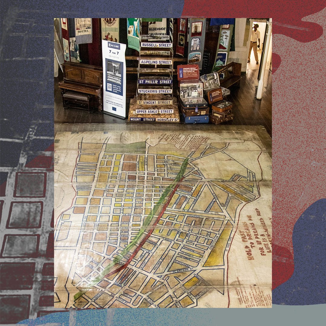 An aerial view of a large street map of District Six on Museum with an exhibit of old street signs and banners.