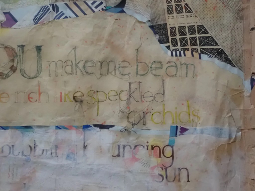 Second of four photographs forming a sequence. This one is of a collage of torn paper with ornate text.