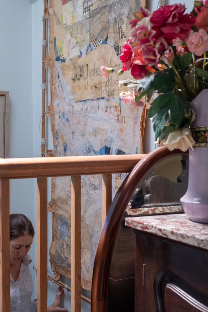 Four photographs show a woman with her hand on a balustrade as she looks back toward the camera and then proceeds to walk down a flight of stairs.
