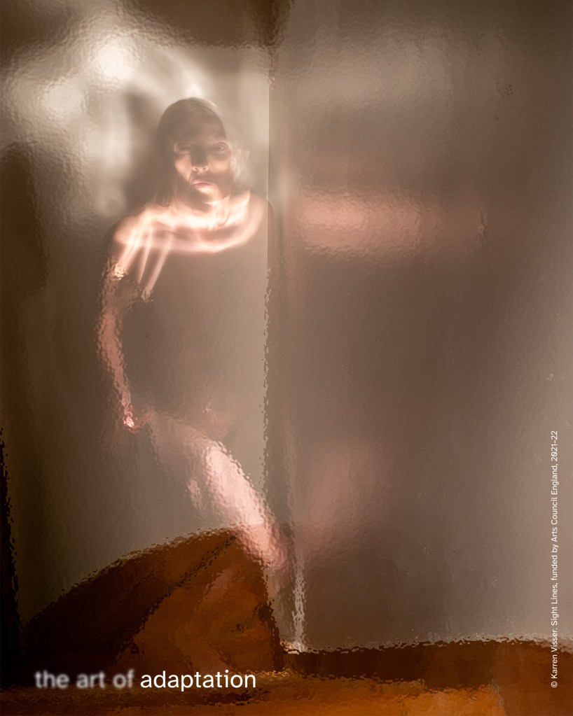 Blurred, warm-toned image of a nude woman behind rippled glass. Positioned left of centre on a staircase. Her searching expression is clearest. Text reads “the art of adaptation.”  © Karren Visser. Seeing in Isolation, produced by Multistory and Karren Visser, 2021.
